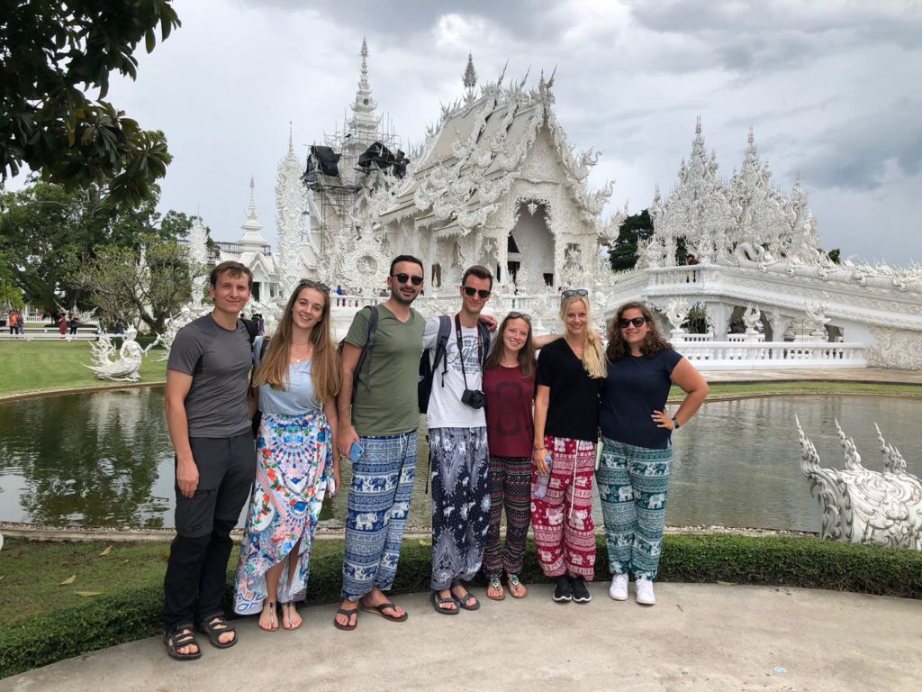 the group in front of the white temple in chiang rai