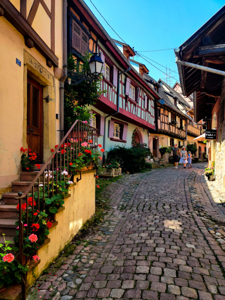 A beautiful street with old houses in eguisheim, one of the most beautiful towns in the Alsace region in France (europe). Resembles a disney movie.